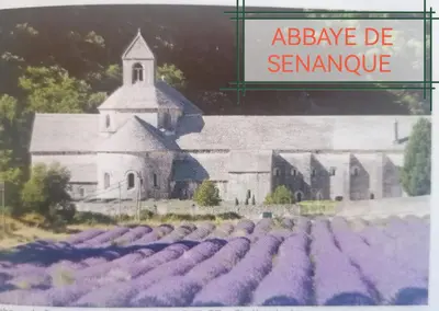 a picture of a church with a field of lavender at la fée viviane et michel l'enchanteur in Robion en Luberon