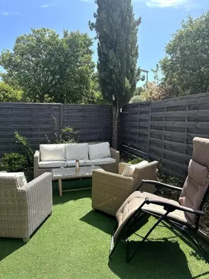 a patio with chairs and a couch and a table at Ocra Pure in Roussillon
