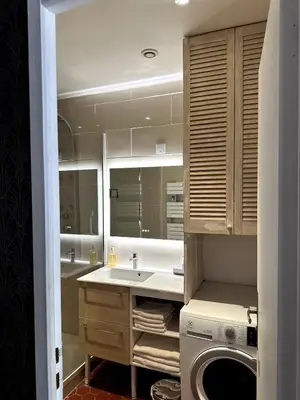 a bathroom with a sink and a washing machine at Ocra Pure in Roussillon
