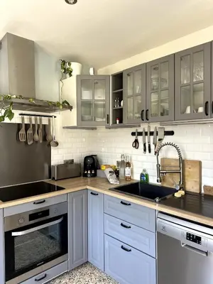 a kitchen with white cabinets and a sink at Ocra Pure in Roussillon