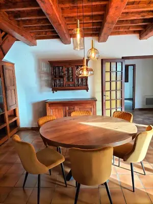 a dining room with a wooden table and chairs at Maison Provençale Spa Sauna Piscine in Mollégès