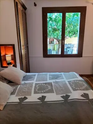 a large bed in a bedroom with a window at Maison Provençale Spa Sauna Piscine in Mollégès