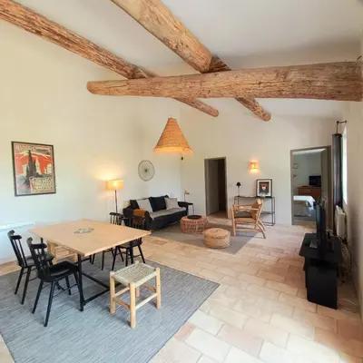 a living room with a table and chairs at Le Cottage du Chat Blanc in Saint-Didier