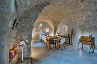 a dining room with a table and a piano at Maison Lou Roucas in Cabrières-dʼAigues