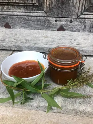 a jar of honey next to a bowl of sauce at Maison Lou Roucas in Cabrières-dʼAigues