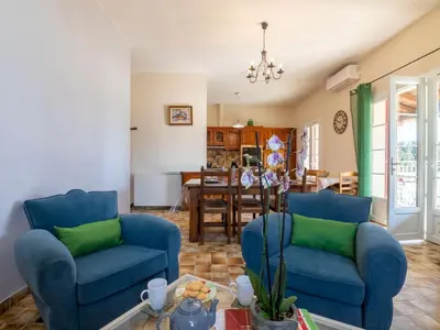 a living room with two blue chairs and a table at Holiday Home Mas de la Gourmette by Interhome in Châteaurenard