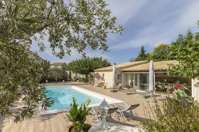 a villa with a swimming pool and a house at Villa Mireillo in Noves