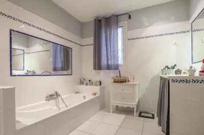a bathroom with a tub and a sink at Villa Mireillo in Noves
