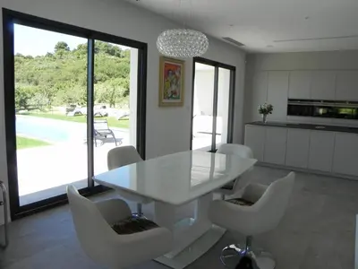 a white dining room with a white table and chairs at Là Mésange de Venasque in Venasque