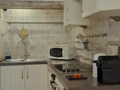 a kitchen with a sink and a microwave at Charmant appartement avec clim - centre historique in Aix-en-Provence
