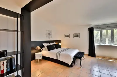 a bedroom with a bed and a window at Quintessence Provence in Goult
