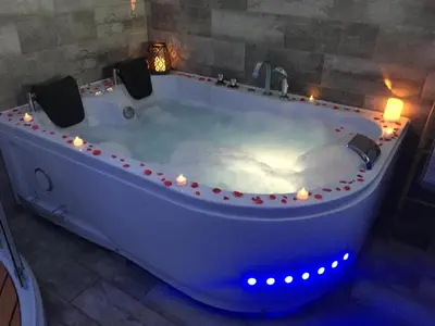 a large white bath tub with lights in a room at Esprit Zen en Provence Studio Spa privatif in Cheval-Blanc