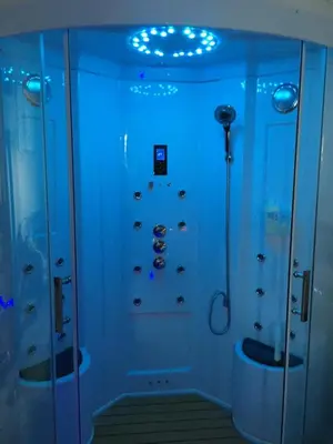 a bathroom with a shower with blue lights at Esprit Zen en Provence Studio Spa privatif in Cheval-Blanc