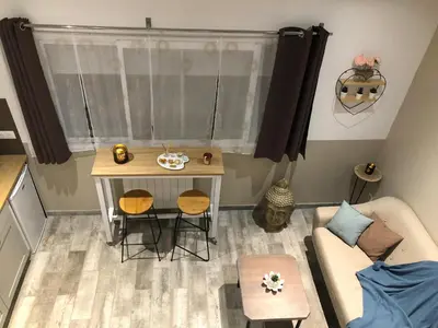 a small living room with a table and chairs at Esprit Zen en Provence Studio Spa privatif in Cheval-Blanc