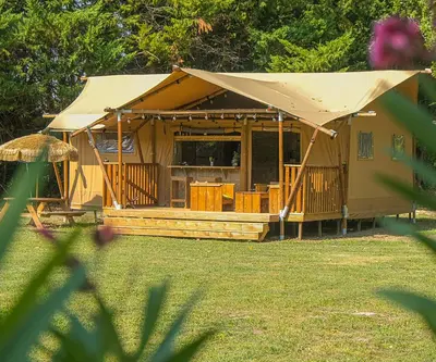 a large building with a tent in a yard at Lodge St Exupéry in Le Thor