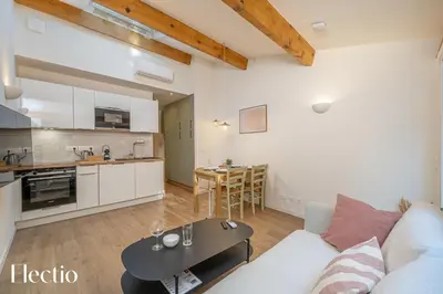 a living room with a couch and a table at Les Nids de la Diane - Appart'Conforts in Pertuis