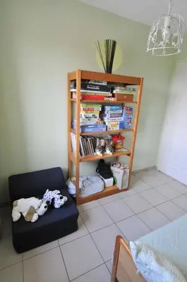 a room with a book shelf and a couch at Gîte de Catherine in Saint-Didier