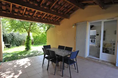 a patio with a table and chairs on a patio at Gîte de Catherine in Saint-Didier