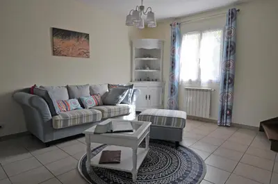 a living room with a couch and a table at Gîte de Catherine in Saint-Didier