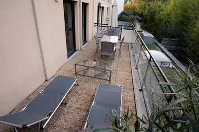 a group of benches and tables on a balcony at Floridianes by HRI in Aix-en-Provence