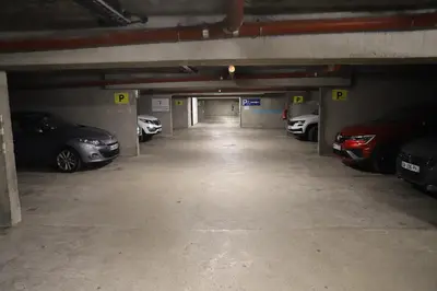 a parking garage with several cars parked in it at Floridianes by HRI in Aix-en-Provence