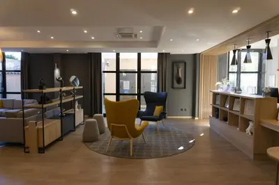 a living room with two chairs and a table at Floridianes by HRI in Aix-en-Provence