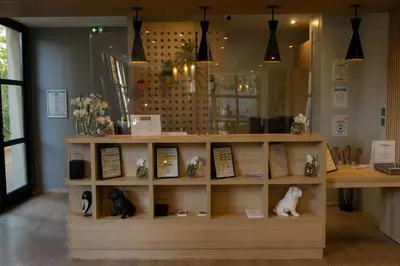 a room with a shelf with figurines of cats on it at Floridianes by HRI in Aix-en-Provence
