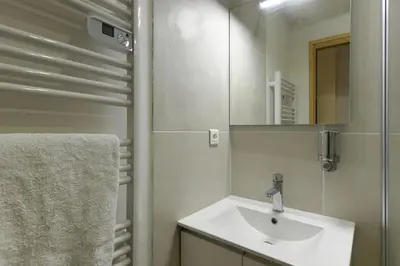 a bathroom with a sink and a mirror at Provençal Studio Netflix Appart-hotel-Provence in La Fare-les-Oliviers