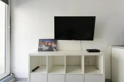 a white cabinet with a television on top of it at Provençal Studio Netflix Appart-hotel-Provence in La Fare-les-Oliviers