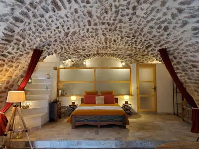 a bedroom with a bed and a ceiling covered in shells at Moulin de Bonfilhon in Cornillon-Confoux