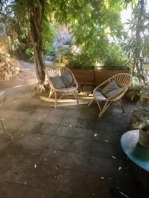 two chairs and a table on a patio at La petite maison in Lourmarin