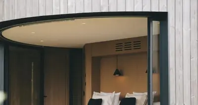 a reflection of a room with a mirror at Hôtel le Jas de Joucas in Joucas