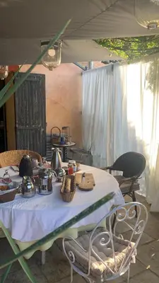 a table with tea pots and baskets on it at la villageoise, chambre troglodyte pitoresque au cœur du village in Rognes