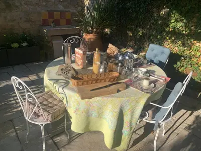 a table with a basket of food on it at la villageoise, chambre troglodyte pitoresque au cœur du village in Rognes