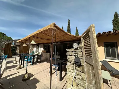 a bedroom with a bed and a side table at Mas la Provence in LʼIsle-sur-la-Sorgue