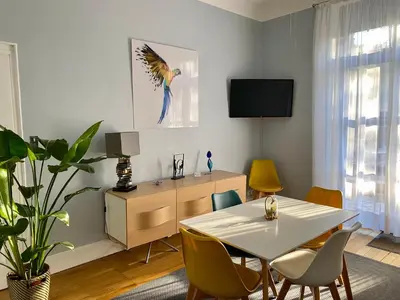 a dining room with a white table and chairs at Villa Suzanne - Lambesc centre in Lambesc