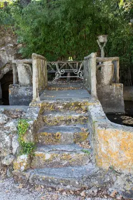 a stone staircase leading to a park bench at Villa Suzanne - Lambesc centre in Lambesc