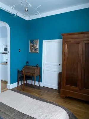 a room with a table and a blue wall at Villa Suzanne - Lambesc centre in Lambesc