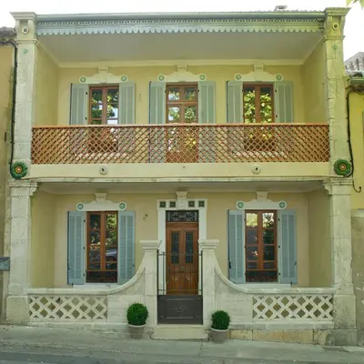 a large house with a balcony on top of it at La Treille et L'Impasse in Ansouis