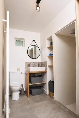 a bathroom with a sink and a toilet at La Velleronnaise in Velleron