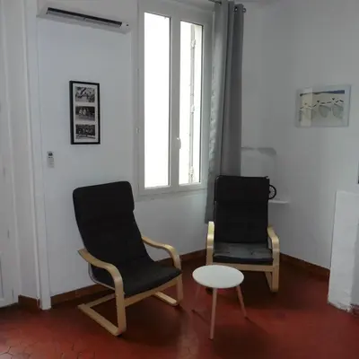 two chairs and a table in a room with a window at Villa Zola in Aix-en-Provence