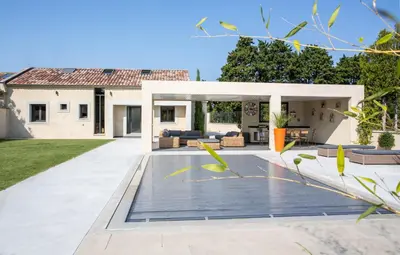 a backyard with a patio and a house at VILLA PALMA & SPA in LʼIsle-sur-la-Sorgue
