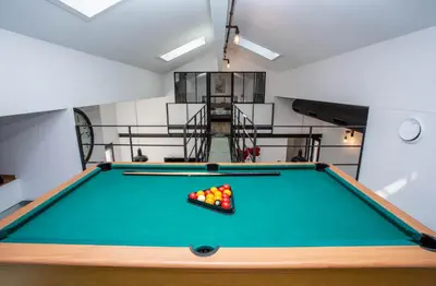a pool table with balls on it in a room at VILLA PALMA & SPA in LʼIsle-sur-la-Sorgue