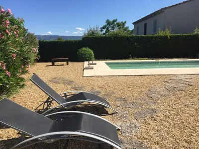 a metal sculpture in a yard next to a swimming pool at Studio Idéal pour des moments d'exceptions in Cabrières-dʼAvignon