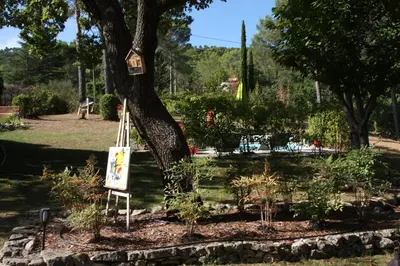 a bird house on a tree in a park at Logis au milieu des pins in Le Puy-Sainte-Réparade