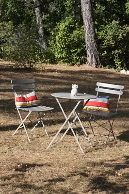 two chairs and a table with a teddy bear sitting on top at Logis au milieu des pins in Le Puy-Sainte-Réparade