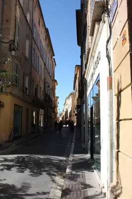 an empty street in a city with buildings at Logis au milieu des pins in Le Puy-Sainte-Réparade