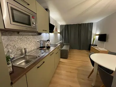 a kitchen with a sink and a microwave at Studio sur le Domaine du Golf de Pont Royal in Mallemort