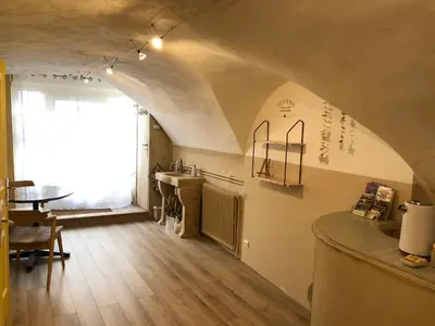 a kitchen and dining room with a table and a window at L'Atelier de Marie in Eyguières