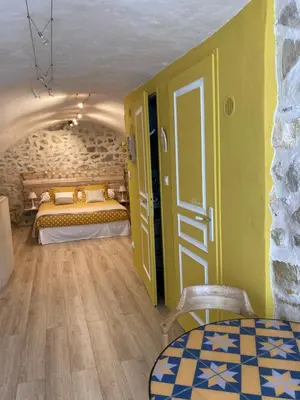 a bedroom with two beds and a room with a door at L'Atelier de Marie in Eyguières